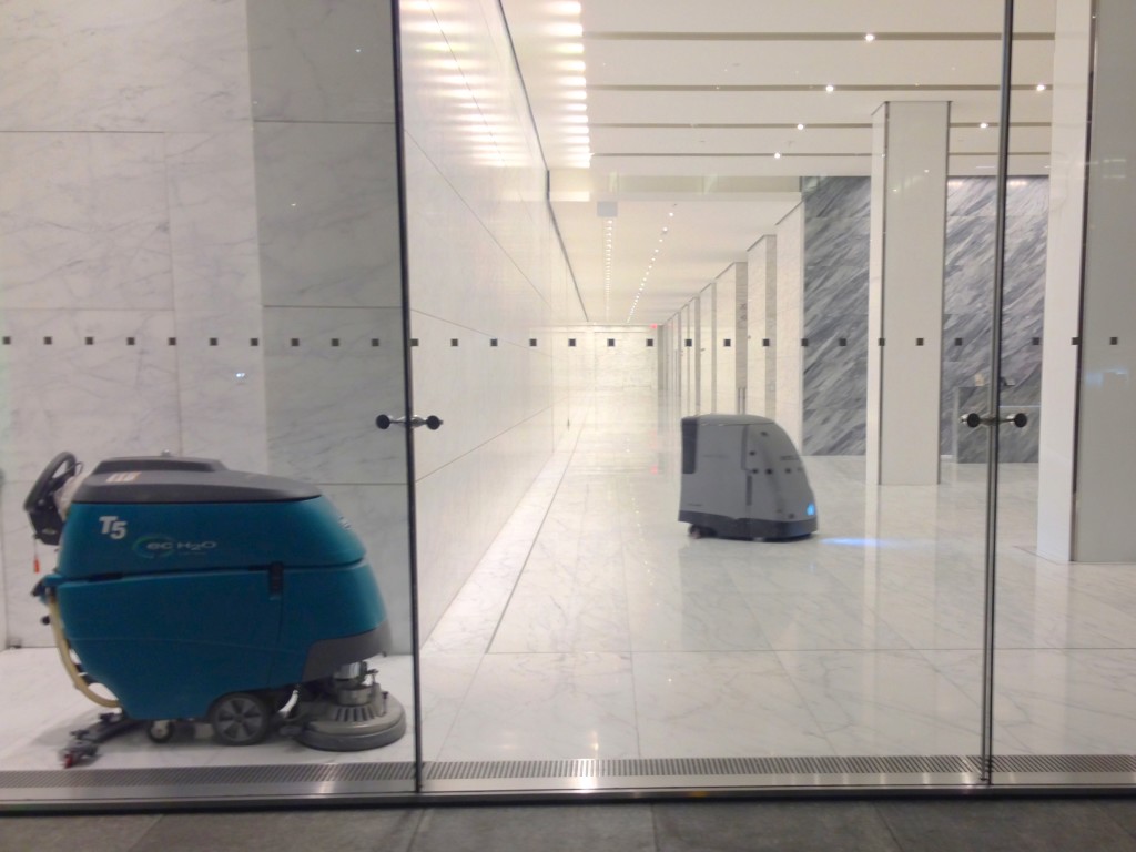 T5 walk-behind floor scrubber by Tennant (left) and HydroBot floor scrubbing robot by Intellibot Robotics picture by Z22